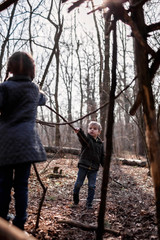 Young adventurers building a wooden habitat in the wild forest during social distant walking