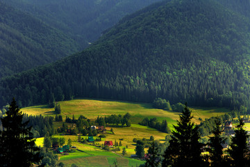 Panoramic view of a Tatra Mountains valley with meadows and farms seen from Toporowa Cyrhla village near Zakopane in Poland