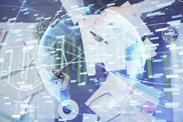 International business hologram over woman's hands taking notes background. Concept of success. Double exposure