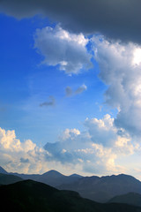 Panoramic view of Western Tatra Mountains with Czerwone Wierchy peaks under a cloudy sky seen from Zakopane in Poland