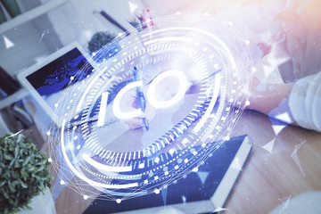 Cryptocurrency hologram over hands taking notes background. Concept of blockchain. Multi exposure