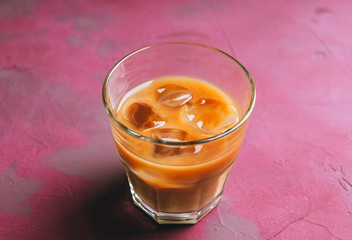 White russian cocktail with ice and cream liquor. Selective focus. Shallow depth of field.