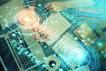 Double exposure of hands making notes with digital coding icons. Computer learning concept.