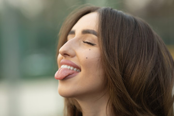 Obraz premium Portrait of beautiful young happy smiling woman, outdoors, with copy space.