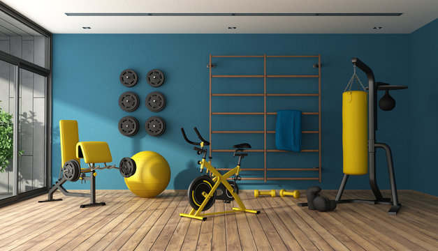 Blue home gym with black and yellow fitness equipment