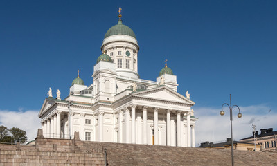 Fototapeta na wymiar Helsinki. Finland St. Nicholas cathedral on the background of blue sky. The square in front of the Helsinki Temple. The architecture of Finland. Orthodox church in Finland.