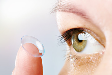 Womans eye and contact lens