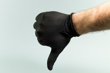 Hand gestures on a gray background in a sterile rubber glove shot with a large lan.