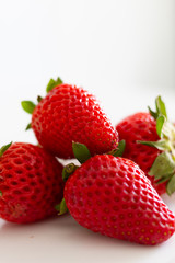 plate of red strawberries on a white background