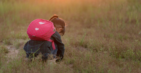Little asian girl hiking in the nature at sunset on summer, Children explore nature for the first time.