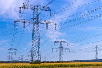 Metal poles electric supports for high-voltage wires in the fields in the summer.