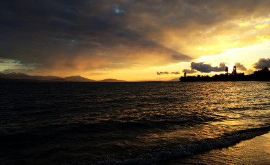 Fototapeta premium a ray of sun through the clouds over the lake