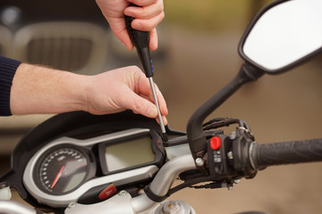 Fototapeta premium Technician hands repairing motobike, doing repair service, maintenance worker repairing vehicle with wrench, service and maintenance motocycle check 