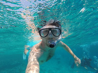 The young man dived under the water. Immersion under water.