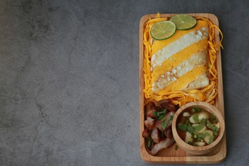 Omelet rice served in wooden plate on cement background