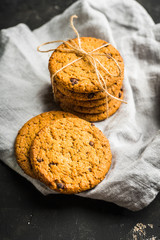 Fresh and healthy cookies with chocolate and seeds on the rustic background. Selective focus. Shallow depth of field.