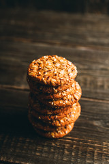 Fresh and healthy cookies with chocolate and seeds on the rustic background. Selective focus. Shallow depth of field.