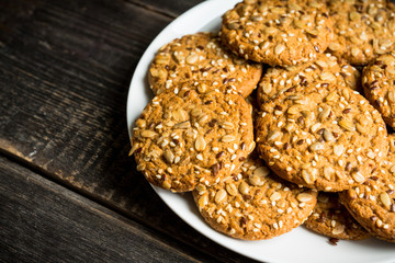 Fresh and healthy cookies with chocolate and seeds on the rustic background. Selective focus. Shallow depth of field.