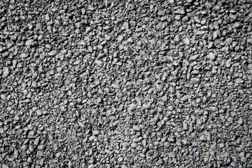 The surface of fresh black asphalt on the road in detail.