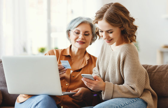 Young woman with mother shopping online at home