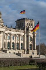 Fototapeta na wymiar German flag fluttering outside the Berlin Bundestag Reichstag or Bundestag, seat of the German Parliament