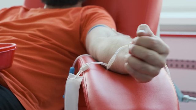 Blood donor showing middle finger close up. Man shows aggressive gesture. Angry donator. Blood donation concept 4k