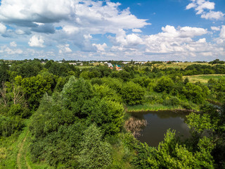Fototapeta na wymiar Picturesque summer countryside landscape whith pond in Russia from a height