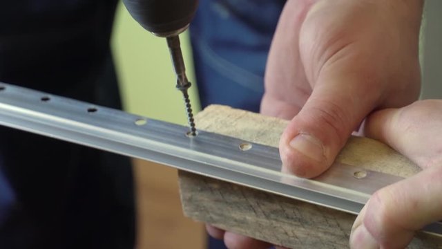 angle bracket or guide on a wooden board, the master fastens with a screwdriver, a self-tapping screw or a screw. Stretch ceiling design.