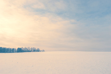 Evening over a clear field with snow
