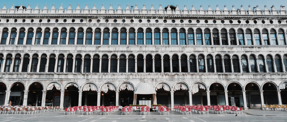 A view of the exterior of Procuratie Vecchie - one of the three connecting buildings on Piazza San Marco, or St. Marks Square, in Venice, Italy. No people concept. Coronavirus Covid-19.