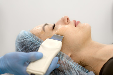 Face cleaning in a beauty salon - close-up of a woman's face