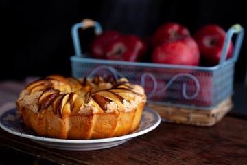 Round apple pie. Homemade pastries. Cupcake with apples on a wooden table. Simple food.