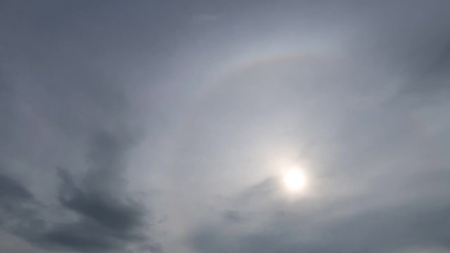 Sunrise in morning with pink sun rays move slowly in cloudy wispy sky background TimeLapse. Time Lapse video of moody gray cloud moving pass sunrise with sunlight. Sunrise break through massive clouds
