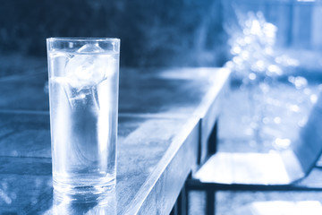 Glass of clean water with ice on table,drinking water