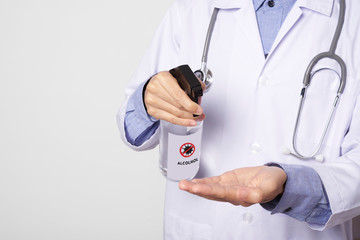 doctor using spray alcohol cleaning hand for protect anti virus bacteria.  Preventive measures against corona virus.