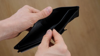 Man Hand Opens An Empty Wallet During Financial Crisis.