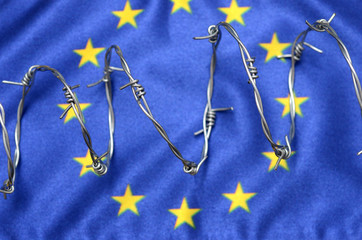 European Union flag and barbed wire, migration to European Union concept