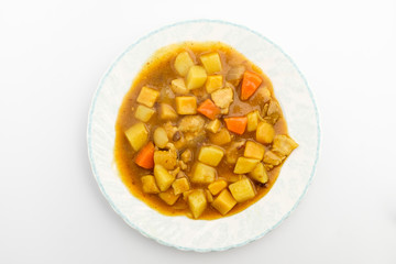 Curry with vegetables on white background