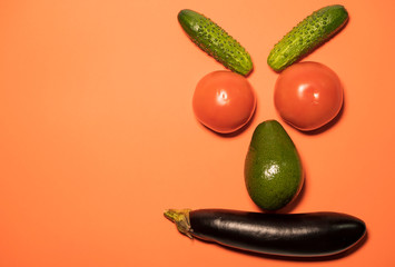 The concept of evil vegetables. Angry face of vegetables on a colored background, a place for your text