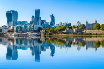 Cloudless day at financial district of London with reflection from River Thames