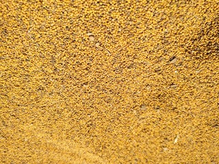 Food background of yellow mustard seeds, top view.