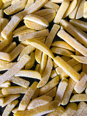 Frozen oven chips seen from above in a baking tin.