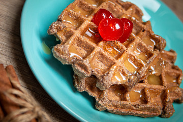 Healthy breakfast waffles with honey and coctail cherries