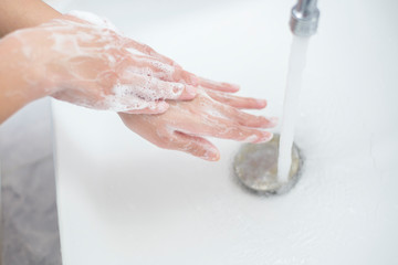 A woman is washing hands