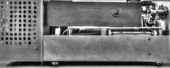 Close up view of a high frequency power amplifier with vacuum tubes in black and white