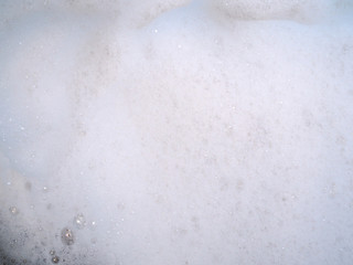 Abstract background with white bubbles blurred on dirty water of washing and rinsing.