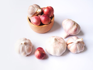 Top view of dried herbs and spices with red shallot and garlic isolated on white background.