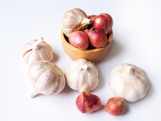 Top view of dried herbs and spices with red shallot and garlic isolated on white background.
