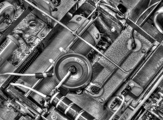 Inside view of high frequency power amplifier with capacitors, coils and other components in black...