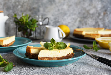 New York lemon cheesecake on a concrete background.
